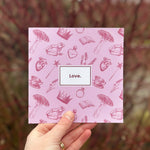 Load image into Gallery viewer, Show your affection with stationery! Our &#39;Love&#39; greetings card is the perfect year-rounder! Valentine&#39;s, Galentine&#39;s, Birthdays, Weddings and anniversaries, this quirky card is the perfect addition to our greetings card collection. Complete with kraft paper envelope and blank inside for your message - each of our cards arrives packed in a sealed compostable bag.
