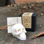 Load image into Gallery viewer, The nights are drawing in and the leaves are beginning to fall! - time to cosy up and enjoy spooky season with this gorgeous skull candle from The Upturned Cauldron.  Learn their curious origin story beautifully presented in this gift box - the perfect addition to your abode this season, if you can bear to light it!
